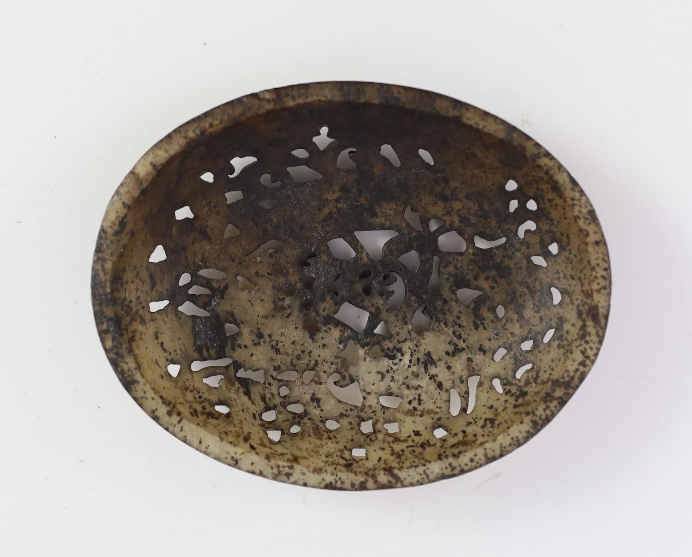 A Chinese pale grey and black jade oval plaque, Yuan dynasty or later, 11cm wide
